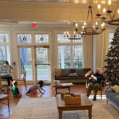 Children and adults spend time near the Christmas tree at Trinity Retreat Center