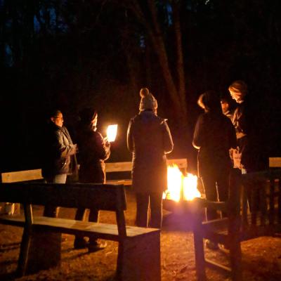 Retreatants gathered around a campfire
