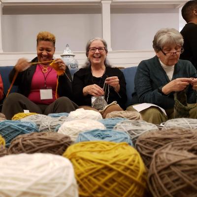 Trinity Knitters at Trinity Retreat Center with yarn in front of them