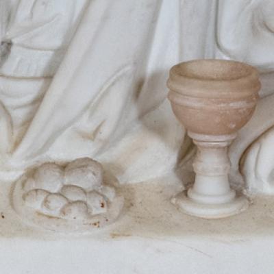 Marble relief of chalice and plate of bread