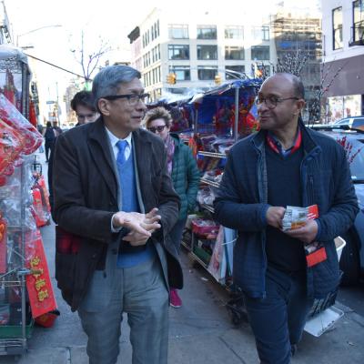 Wellington Chen (left) and the Rev. Phillip Jackson (right) walk through Chinatown in conversation.