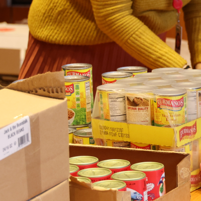 Image of volunteer packaging cans of food