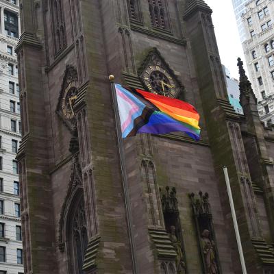 The Progress Pride Flag flies in front of Trinity Church Wall Street