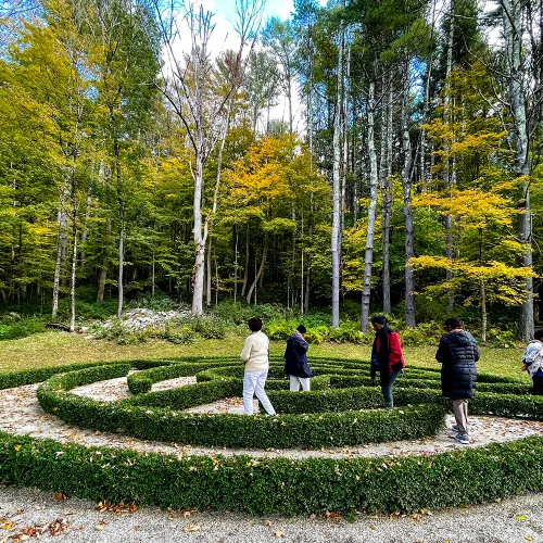 People walk in the hedge maze at the Trinity Retreat Center