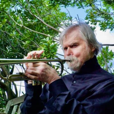 Tom Harrell with trumpet in a park.