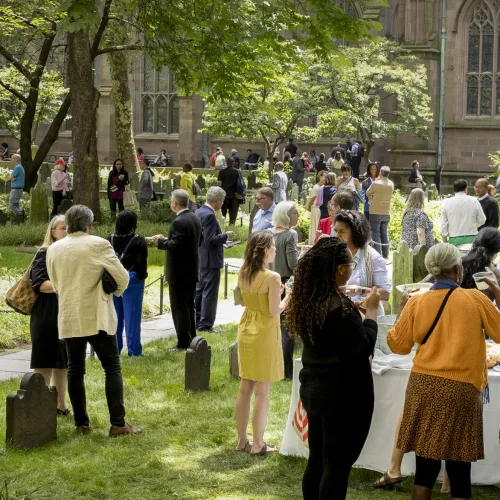 Trinity parishioners gathering for a picnic in the Trinity Churchyard