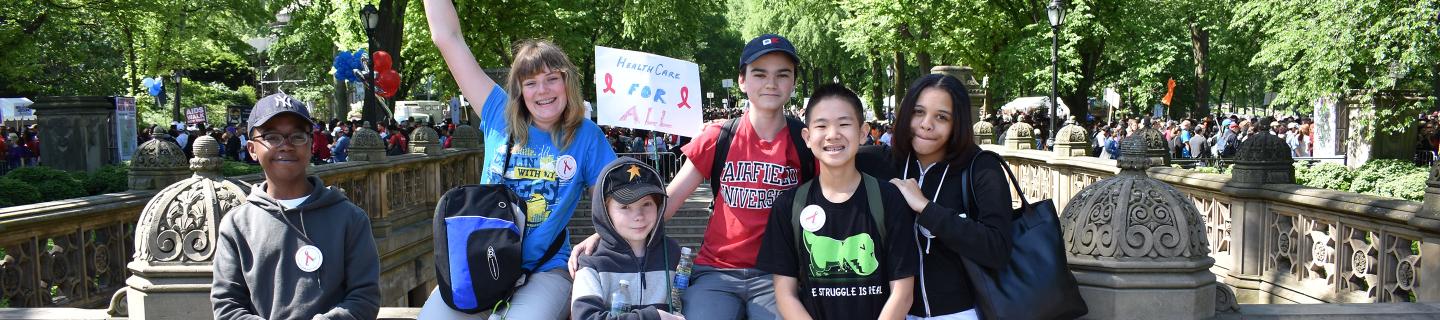 Trinity youth hold signs and participate in AIDS Walk New York