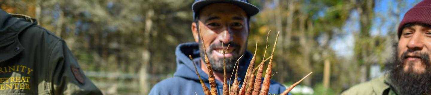 Caretaker Ashraf Aljasem and farm manager Patrick Beal harvest carrots