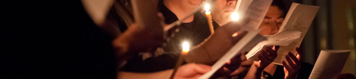 People at Compline holding candles and service programs